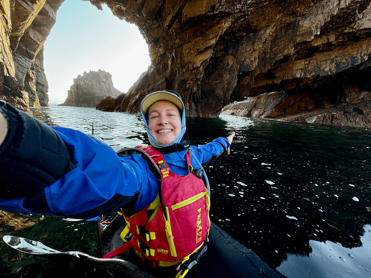 Ariel Gazarian kayaking in a sea cave in Ireland